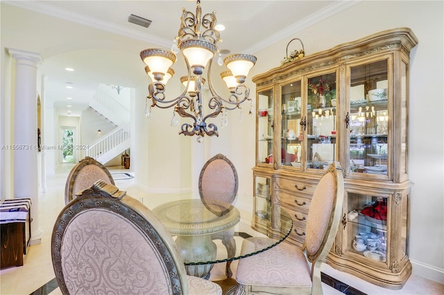 tiled dining area with a chandelier, decorative columns, and ornamental molding