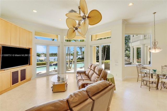 living room featuring french doors, ornamental molding, light tile flooring, and a wealth of natural light