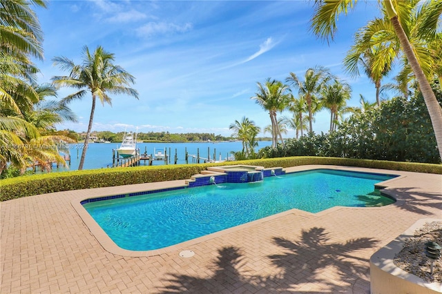 view of pool featuring an in ground hot tub, a water view, a dock, and a patio area