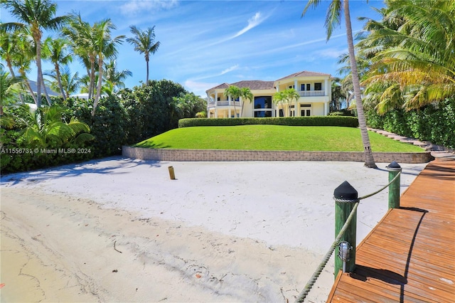 exterior space featuring a balcony and a yard