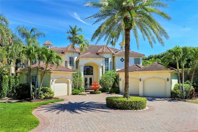 mediterranean / spanish house with a garage