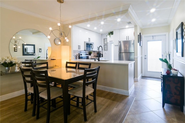 dining space with dark hardwood / wood-style flooring, crown molding, and sink