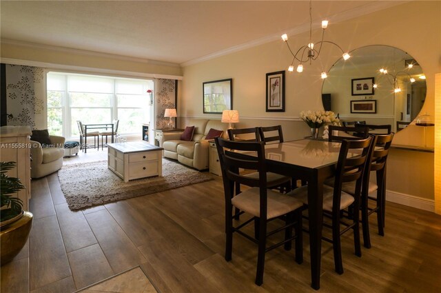 dining room with crown molding, dark wood-type flooring, and a notable chandelier