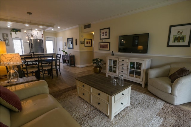 living room with wood-type flooring and ornamental molding