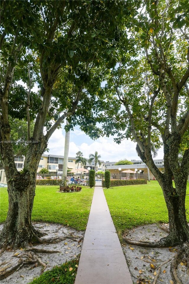 view of home's community featuring a lawn