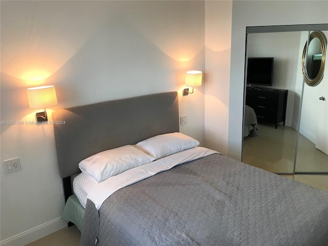 bedroom featuring a closet and concrete flooring