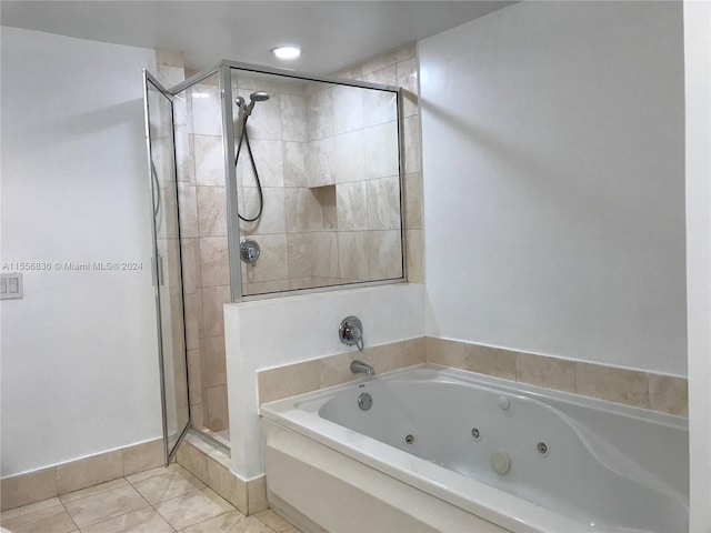 bathroom with shower with separate bathtub and tile floors