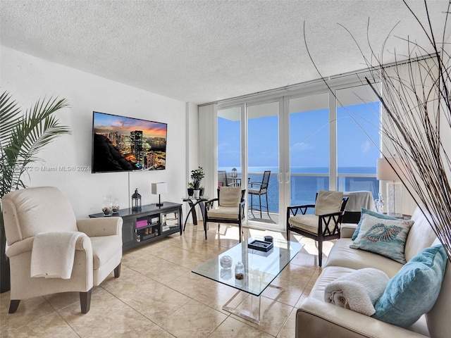 tiled living room with a textured ceiling and a wall of windows