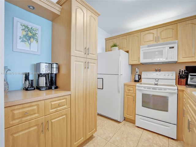 kitchen with white appliances, light brown cabinets, and light tile patterned floors