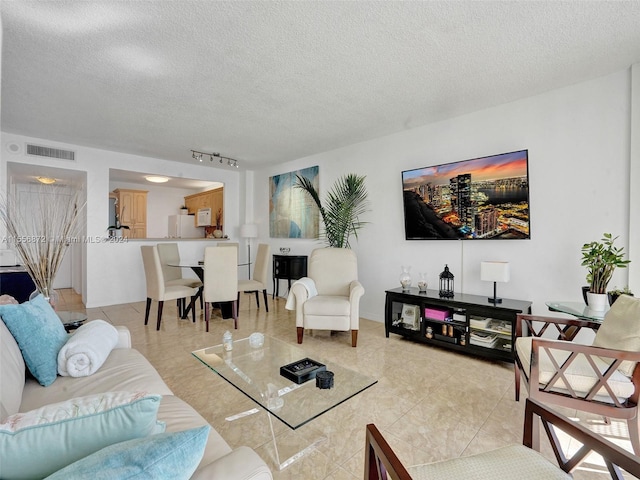 tiled living room with a textured ceiling