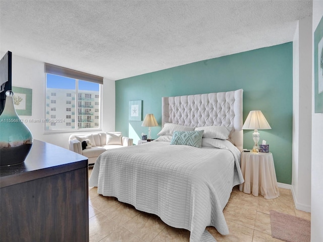 tiled bedroom with a textured ceiling