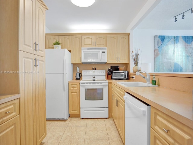 kitchen featuring white appliances, light brown cabinets, light tile patterned floors, and sink