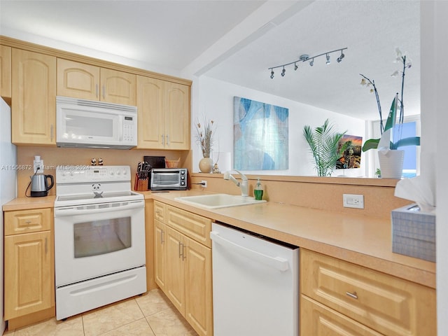 kitchen featuring white appliances, light brown cabinetry, light tile patterned floors, and sink