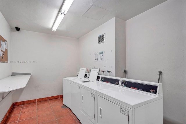 laundry area featuring washer and clothes dryer and light tile patterned floors