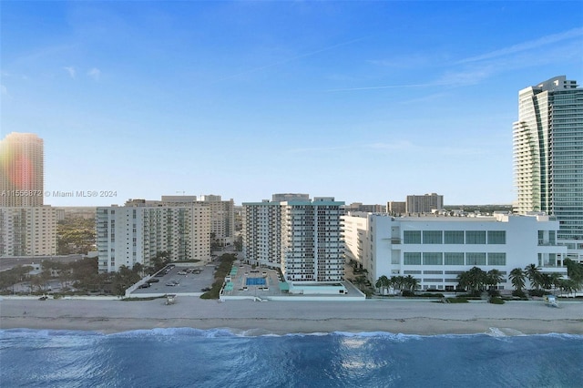 view of building exterior with a view of the beach and a water view