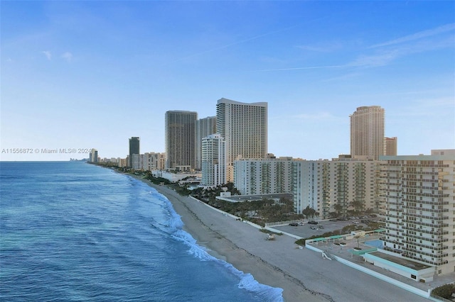 birds eye view of property with a view of the beach and a water view