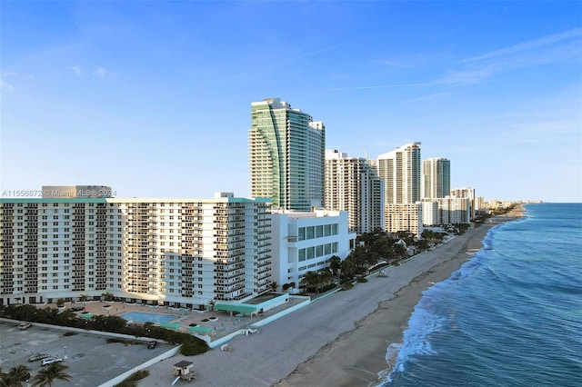 exterior space with a water view and a beach view