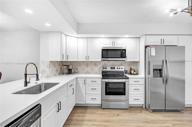 701 SW 142nd Ave Unit 108S, Pembroke Pines, FL 33027 - kitchen with stainless steel appliances, a sink, recessed lighting, light countertops, and white cabinets