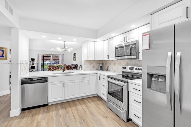 701 SW 142nd Ave Unit 108S, Pembroke Pines, FL 33027 - kitchen with appliances with stainless steel finishes, light wood-style flooring, a sink, light countertops, and recessed lighting