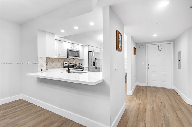 701 SW 142nd Ave Unit 108S, Pembroke Pines, FL 33027 - kitchen with stainless steel appliances, baseboards, tasteful backsplash, light countertops, and recessed lighting