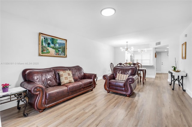 701 SW 142nd Ave Unit 108S, Pembroke Pines, FL 33027 - living area with wood finished floors, a chandelier, and baseboards