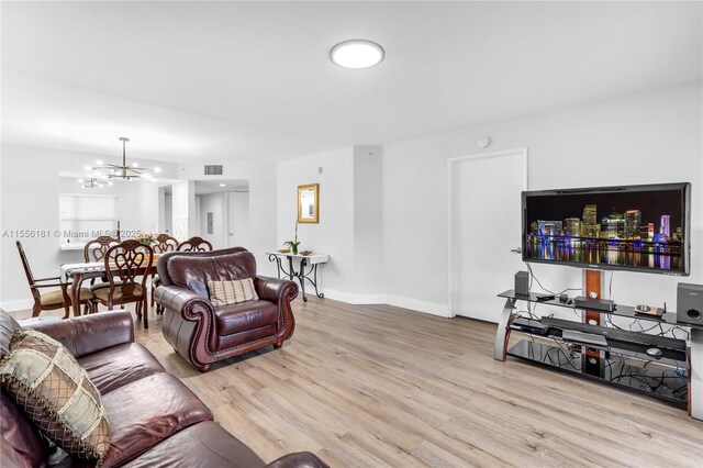 701 SW 142nd Ave Unit 108S, Pembroke Pines, FL 33027 - living area featuring a chandelier, wood finished floors, and baseboards