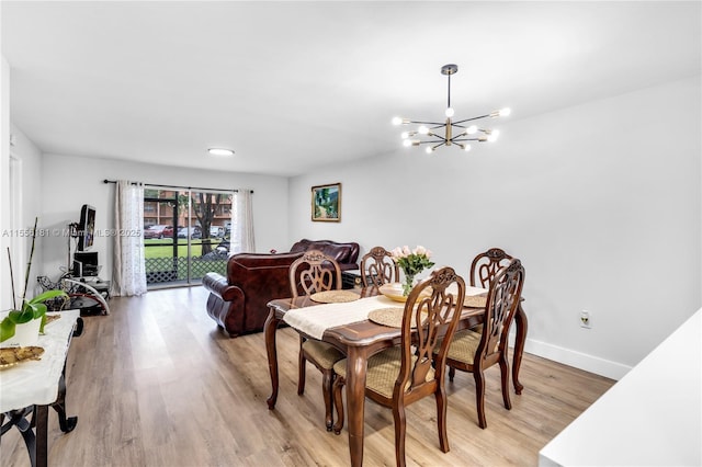 701 SW 142nd Ave Unit 108S, Pembroke Pines, FL 33027 - dining space featuring a chandelier, light wood-style flooring, and baseboards