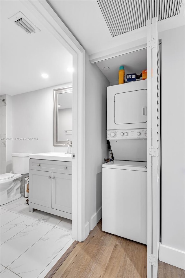 701 SW 142nd Ave Unit 108S, Pembroke Pines, FL 33027 - laundry room with stacked washer / drying machine and light wood-style flooring