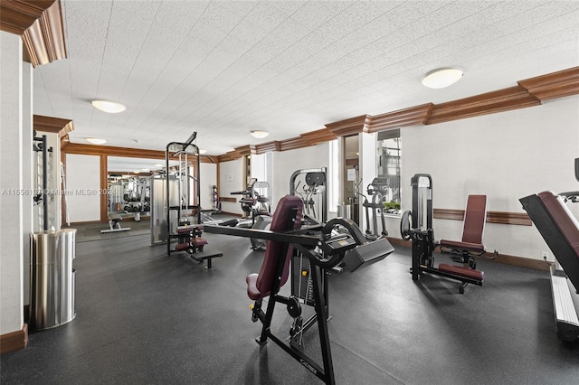 workout area featuring crown molding