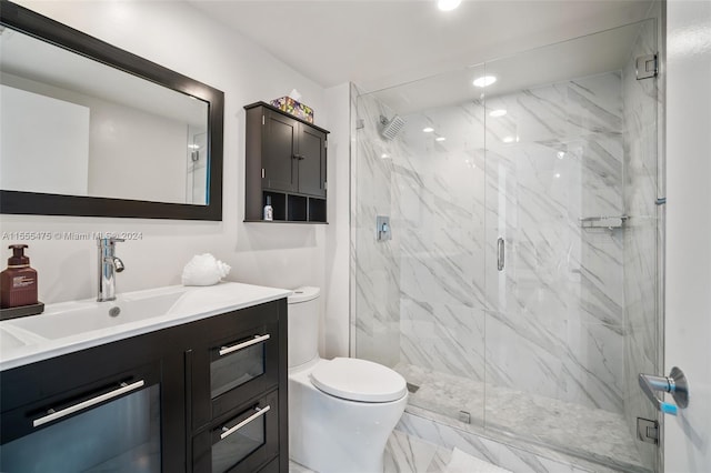 bathroom featuring a shower with door, tile floors, toilet, and vanity