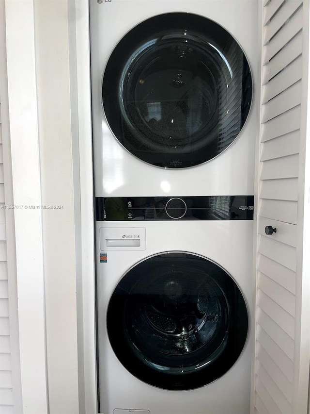 washroom featuring stacked washer and dryer