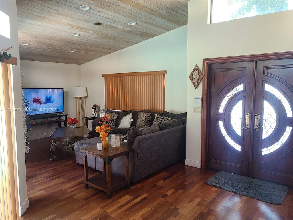 foyer entrance featuring a healthy amount of sunlight, wooden ceiling, and dark wood-type flooring