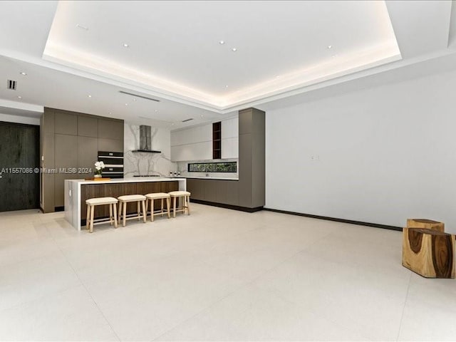 tiled living room with a raised ceiling