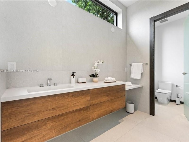 bathroom featuring tile patterned flooring, tasteful backsplash, toilet, and vanity