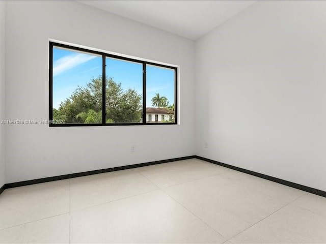 unfurnished room with light tile patterned floors