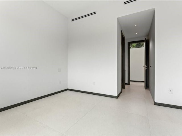 unfurnished room with tile patterned floors