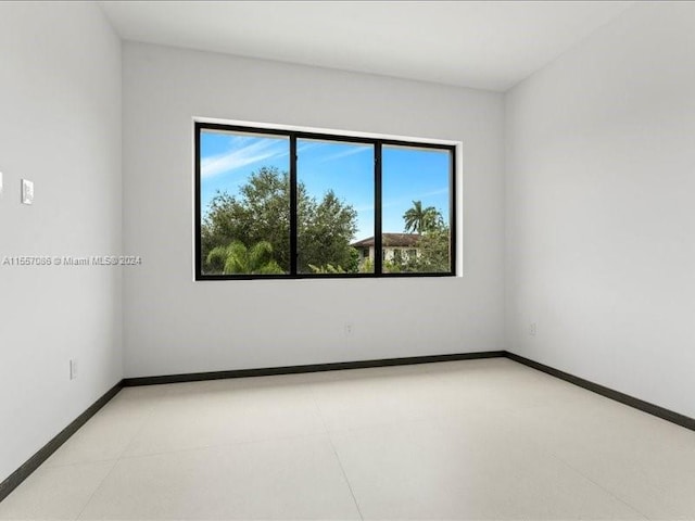 unfurnished room with light tile patterned floors