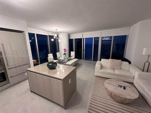 living room with a wall of windows and a notable chandelier