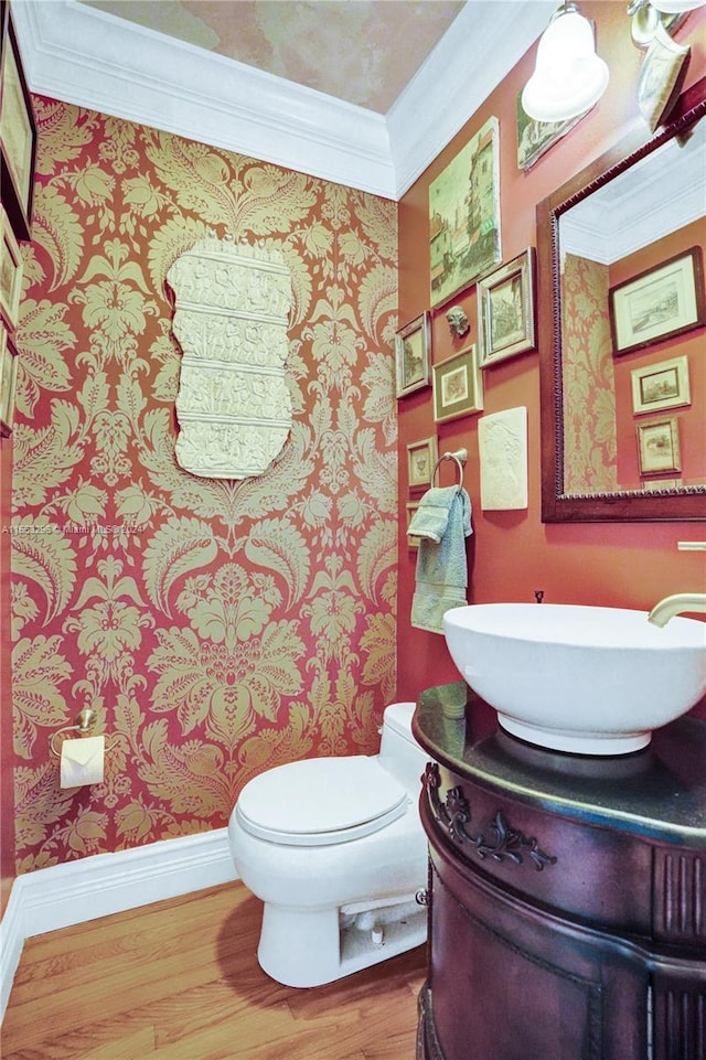 bathroom featuring crown molding, toilet, vanity, and hardwood / wood-style flooring