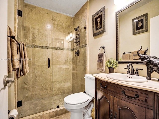 bathroom with toilet, a shower with shower door, and vanity