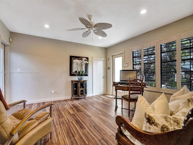 living room featuring ceiling fan and hardwood / wood-style flooring