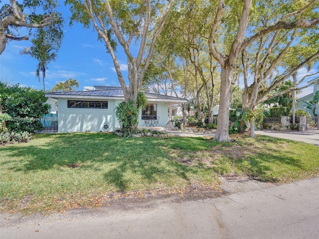 ranch-style home with a front yard and solar panels