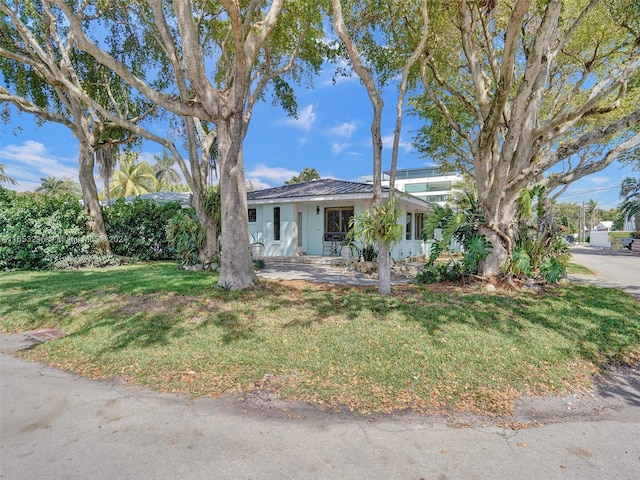 single story home with a front lawn and a porch