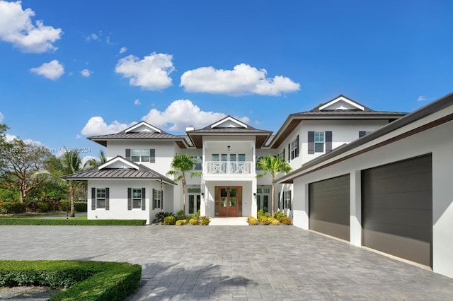 view of front of house featuring a balcony and a garage