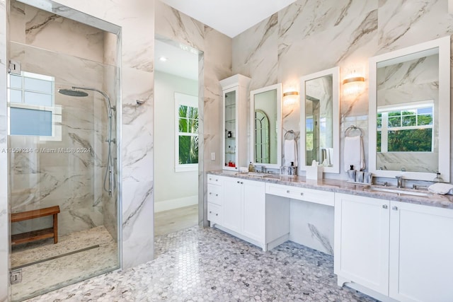 bathroom with a tile shower, a healthy amount of sunlight, dual bowl vanity, and tile flooring