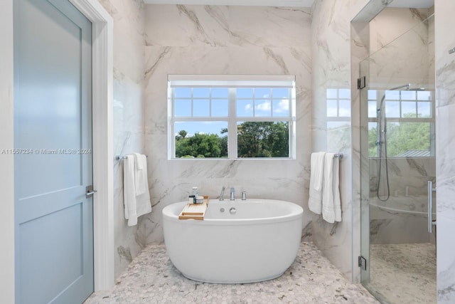 bathroom featuring independent shower and bath and tile walls