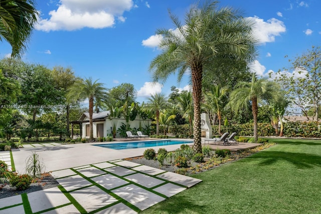 view of swimming pool featuring a yard and a patio area