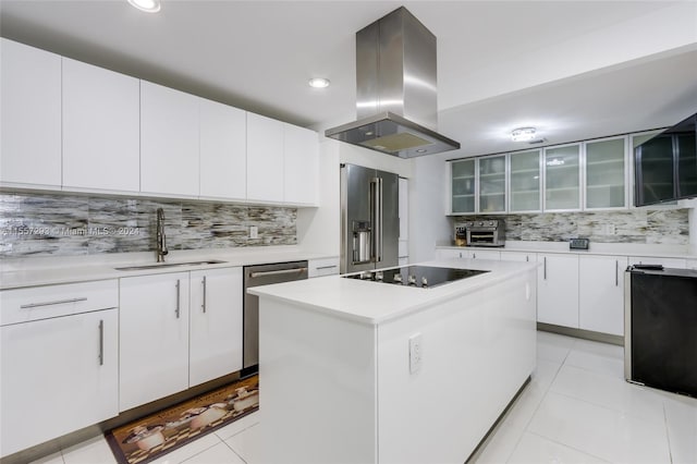 kitchen featuring island range hood, a kitchen island, tasteful backsplash, appliances with stainless steel finishes, and white cabinetry