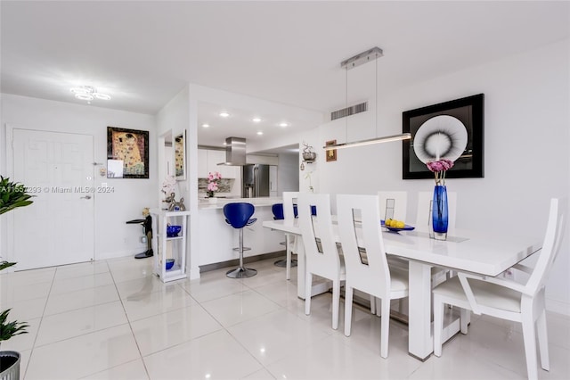 dining space featuring light tile flooring