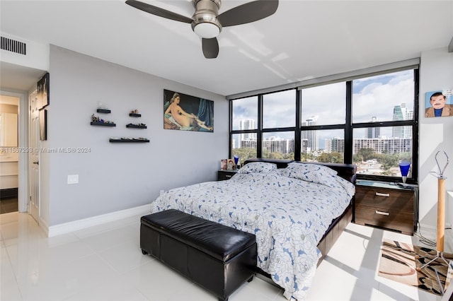 bedroom with light tile flooring, a wall of windows, multiple windows, and ceiling fan